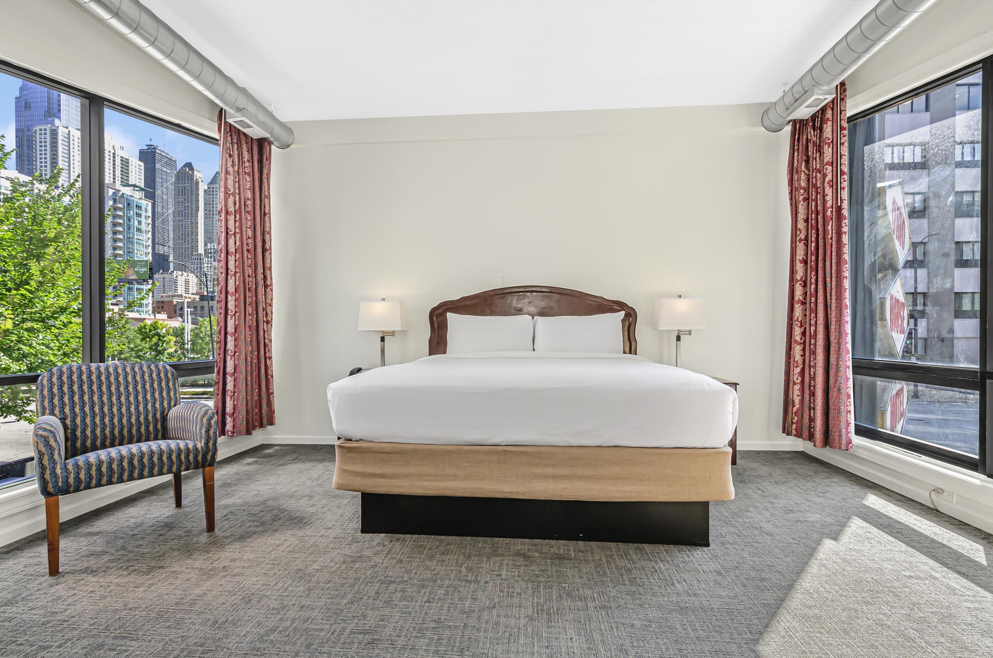 King room, two side tables, lamps, and patterned armchair